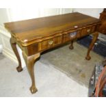 A reproduction hardwood fold-over-top table fitted with three frieze drawers and shaped legs, on