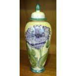 A Lise B Moorcroft blue poppy decorated lustre vase and cover, Chelsea Works Burslem factory mark,