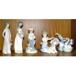 A collection of five Lladro figure ornaments: 'Bashful Bather' (boxed), 'An Elegant Touch' (
