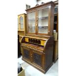 A 19th century mahogany cylinder desk, the fitted desk with pull-out writing surface, above a pair