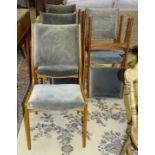A set of six G-Plan-style dining chairs with upholstered backs and seats.
