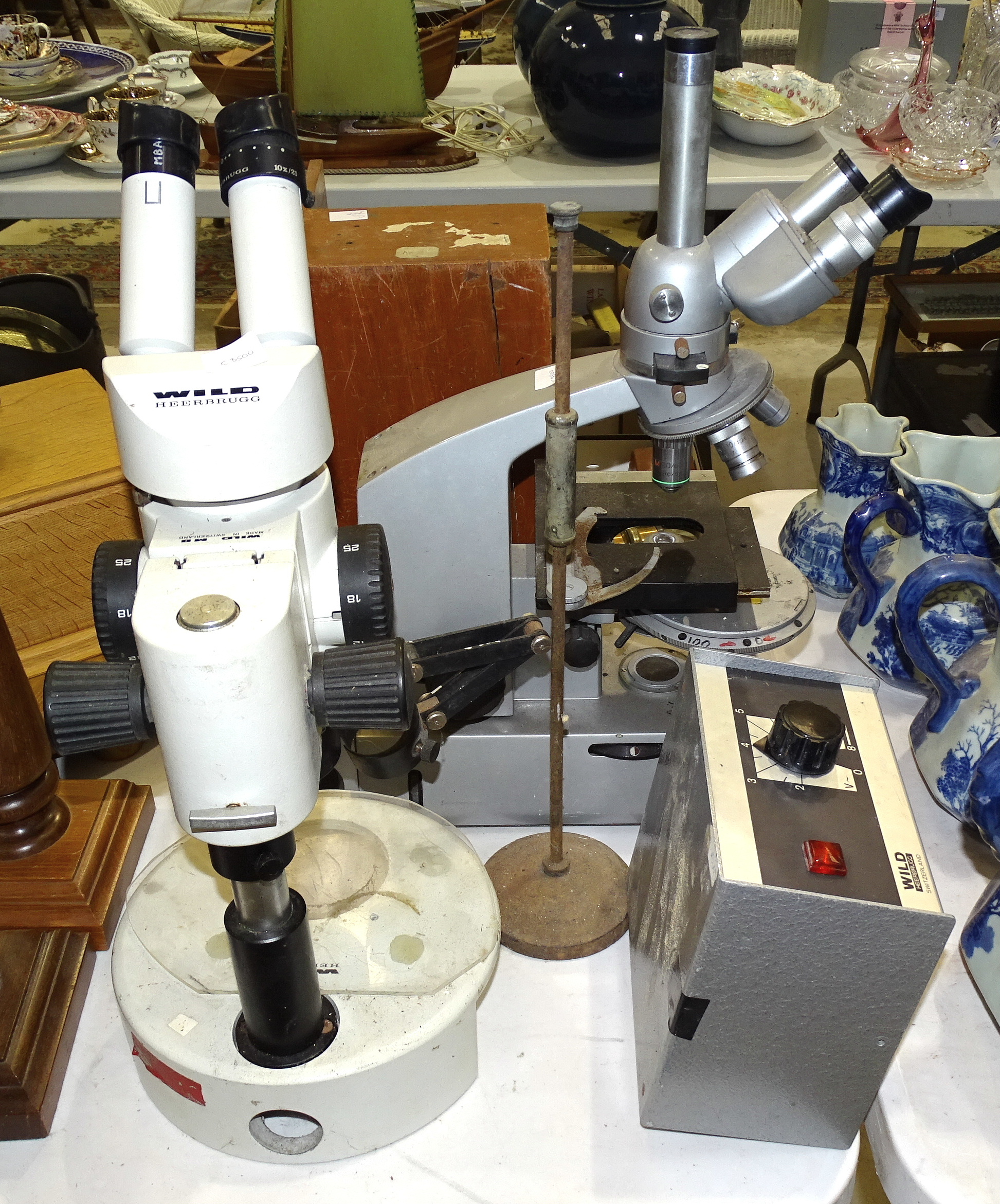 A Wild Heerbrugg binocular microscope, a Reichert binocular microscope, (both a/f), a microscope