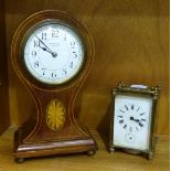 An early-20th century French-made inlaid mahogany balloon-shaped mantel timepiece, the dial marked