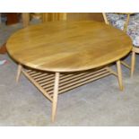 An Ercol oval coffee table with magazine shelf beneath, 98.5 x 82.5cm, 44cm high.