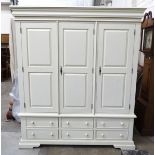 A modern white-finish wardrobe, the cornice above three doors and base fitted with six small