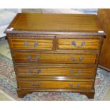 A reproduction inlaid mahogany chest of two short and three long drawers, on bracket feet, 76cm
