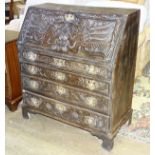 An 18th/19th century carved oak bureau, the fall front with fitted interior, above four graduated