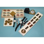 A collection of modern naval ship and space badges and six various wrist watches.