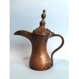 A Middle Eastern copper coffee pot, 33cm high, (purchased in Yemen).