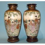 A pair of early-20th century Japanese Satsuma vases, each decorated with panels depicting figures in