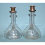 A pair of glass carriage decanters, with sterling silver mounts and twist tops, 14cm high, (2).