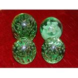 A Victorian green glass dump paperweight with bubble decoration, 11cm high (two chips to near base),
