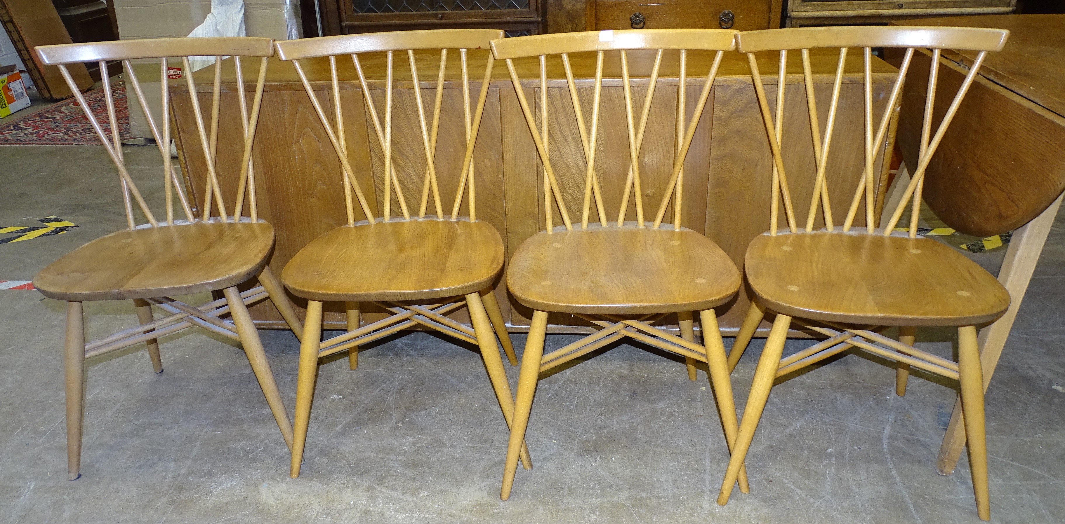 A set of four Ercol 376 candlestick lattice dining chairs together with a low sideboard fitted