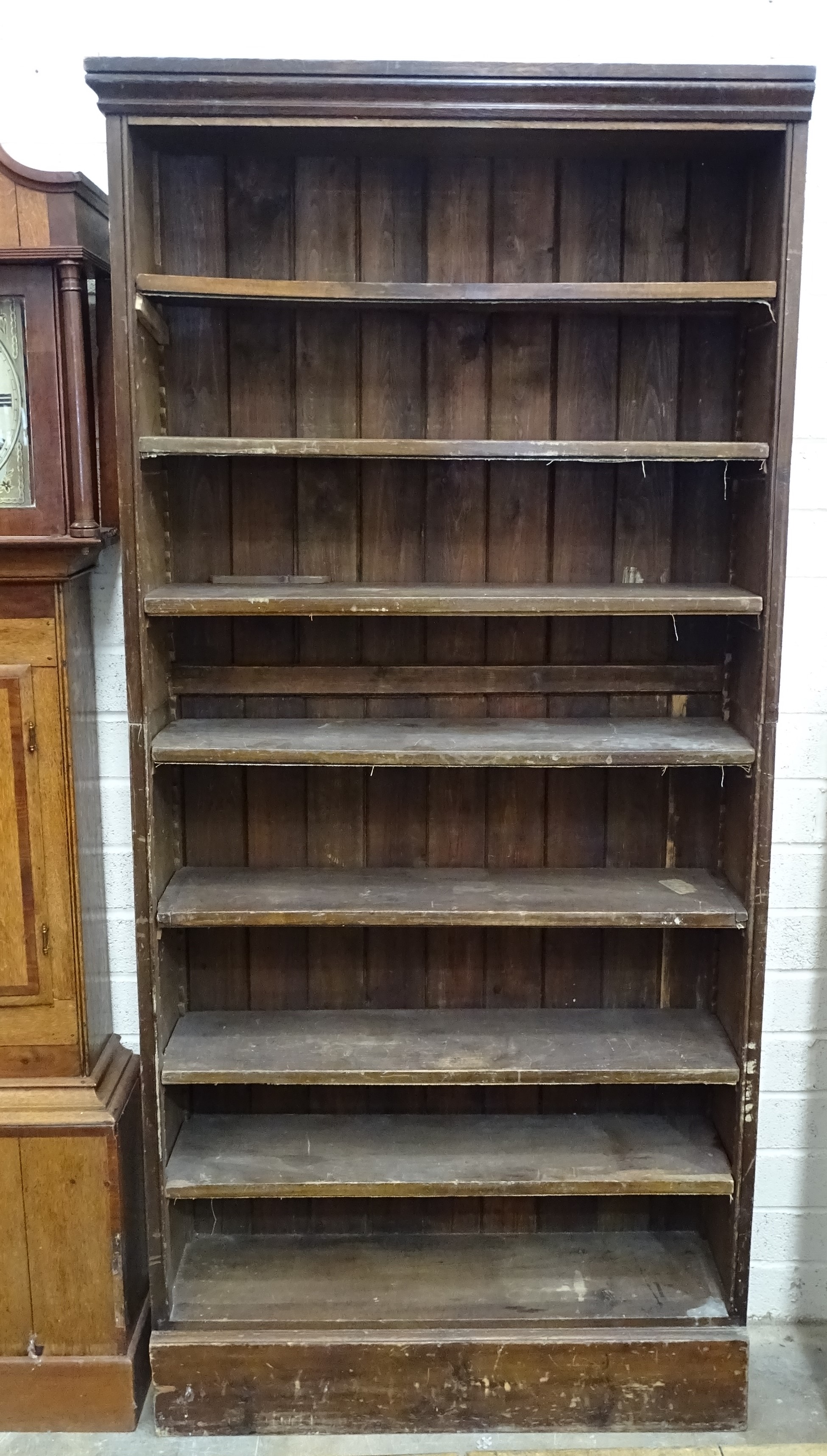 A stained pine open bookcase, 210cm high100cm wide.