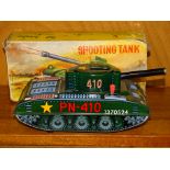 A vintage West German made tin-plate c/w tank, firing wooden shells, 24cm long in original box (