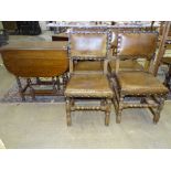 A set of four oak framed dining chairs with leather padded seats and backs and an oak drop-leaf