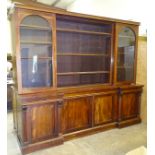 A Victorian mahogany breakfront bookcase, the upper section with central open adjustable shelves