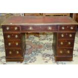 An Edwardian stained wood knee-hole desk having three frieze drawers above six pedestal drawers, 120