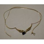 A 9ct gold necklet with pendeloque sapphire below a diamond point, 42.5cm long, 3.6g.