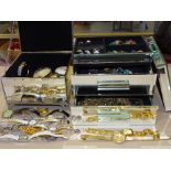 A quantity of costume jewellery and wrist watches in two mirrored jewellery boxes.
