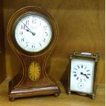 An early-20th century French-made inlaid mahogany balloon-shaped mantel timepiece, the dial marked