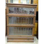 A Globe Wernicke three-section oak bookcase with leaded light doors on a base drawer, 86.5cm wide,