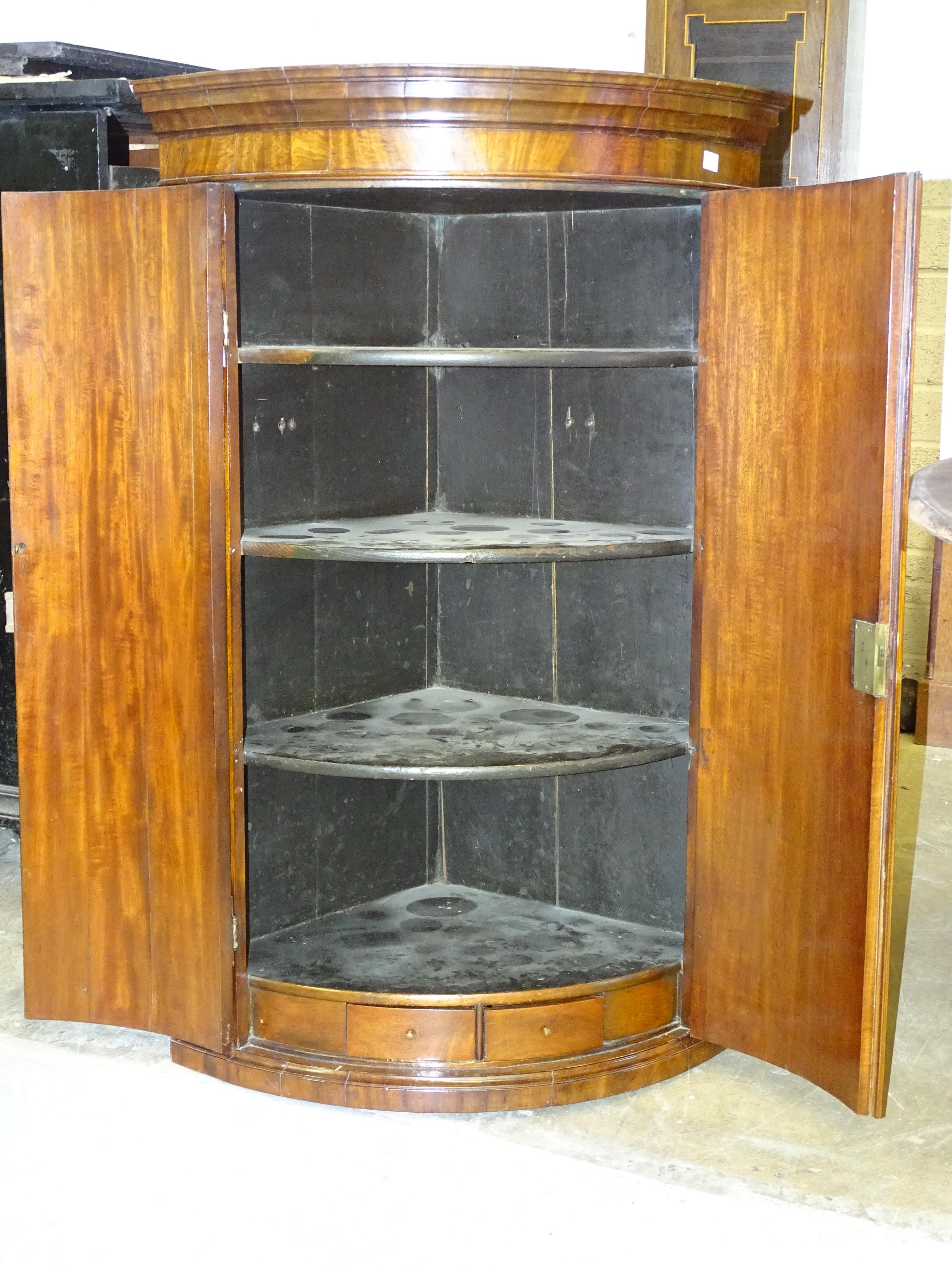 A Georgian mahogany bow fronted two-door hanging wall corner cupboard,76cm wide, 116cm high. - Image 2 of 2