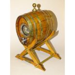 An oak and brass coopered cask with glass end panels, inscribed Made from a piece of one of the