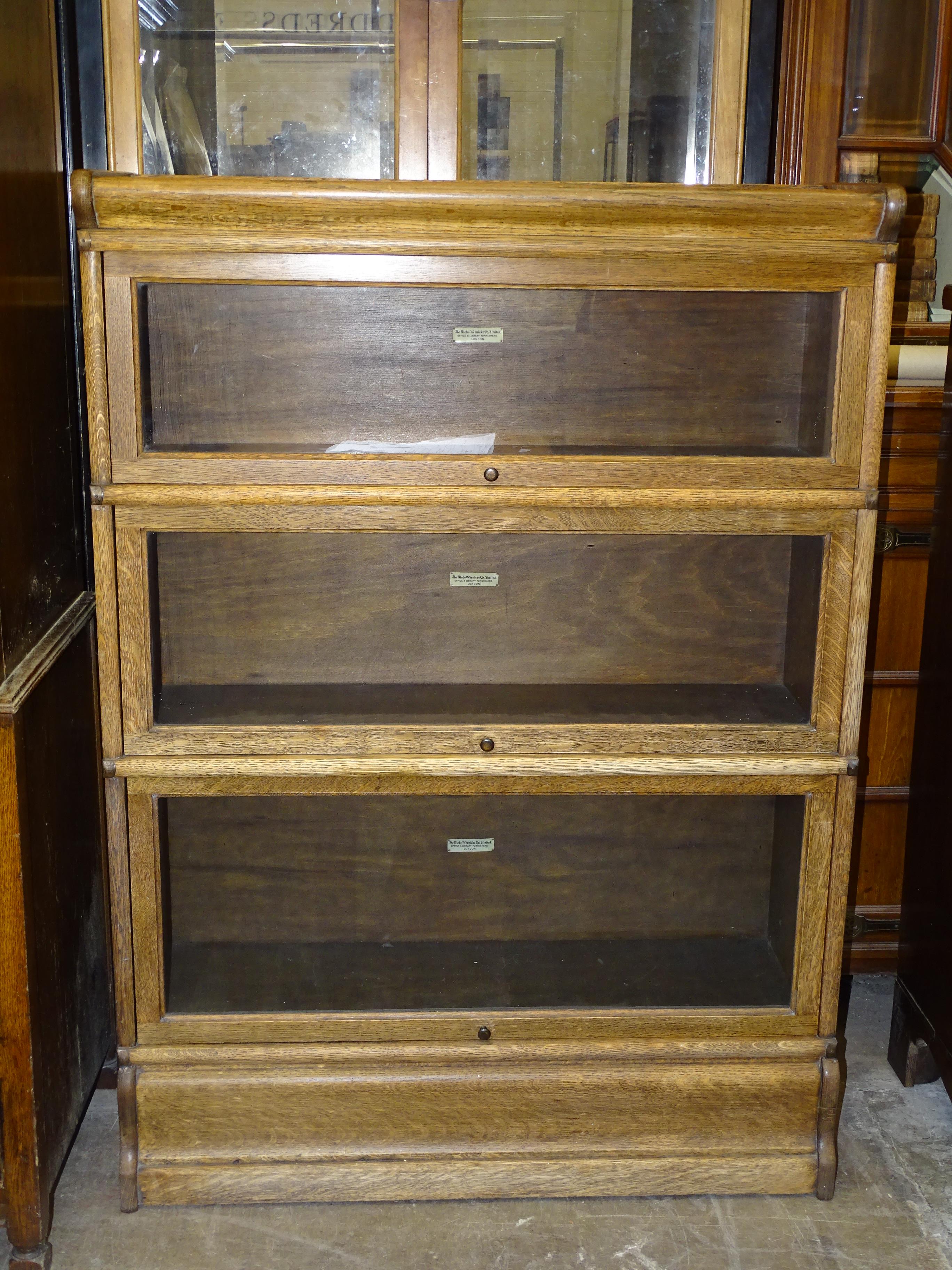 A Globe Wernicke three-section oak bookcase on base, 86.5cm wide, 120cm high, 31cm deep.