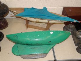 A vintage painted wooden pond yacht hull with lead-weighted keel, 68cm long and one other with