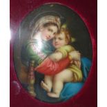 A Continental oval ceramic plaque depicting the Madonna & Child, 8.2 x 6cm, framed.