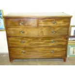 A Georgian mahogany straight-front chest of two short and three long cockbeaded drawers, on