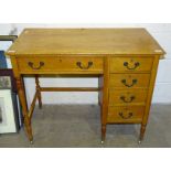 An oak desk, the rectangular top above a frieze drawer and four side drawers, 91 x 49cm, 73cm high.