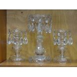 A cut glass lustre vase with drops, 25.5cm high and a pair of smaller lustre vases with drops,