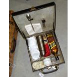 A leather travelling drinks case and a Brexton wicker basket fitted with picnic items, Asprey London