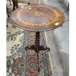 An early-20th century walnut circular-top table, with inlaid leaf and floral decoration, on bobbin-