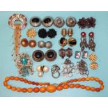 A string of graduated amber-type beads, 50g approximately, a Nina Ricci ear clips and brooch set,