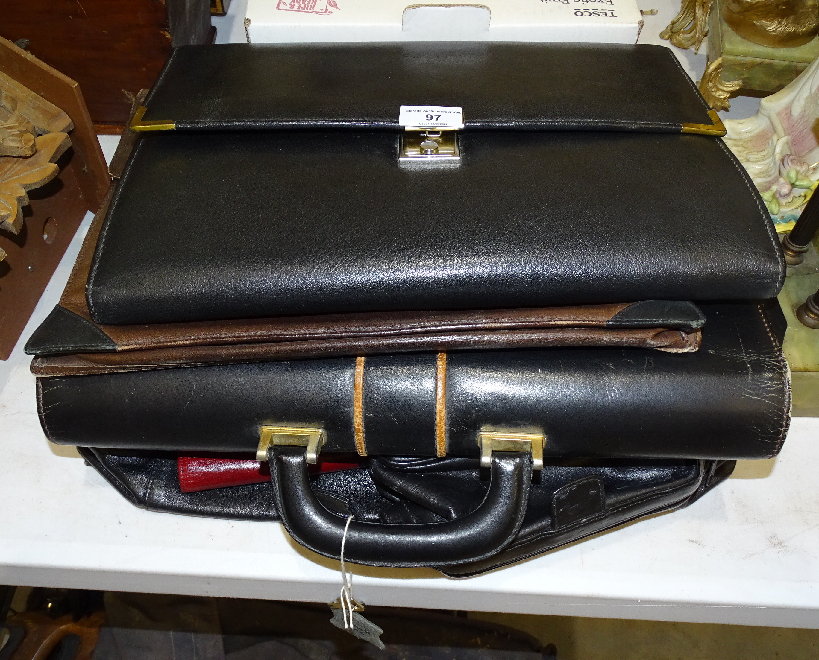 A collection of leather document cases, wallets and other items.