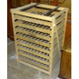 A pine apple storage rack with eight slide-out slatted-bottom trays, 91cm high, 61.5cm wide, 49cm