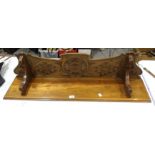 A carved wood hanging wall shelf, 110cm long, 27cm high, (a/f), an oak two-tier table with glass top