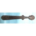 A Trobriand Island Massim hardwood club with incised decoration and pierced tip, 68cm long.