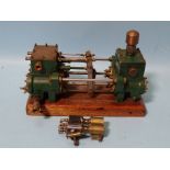 An unmarked twin-cylinder horizontal steam engine and a small brass engine part, (2).