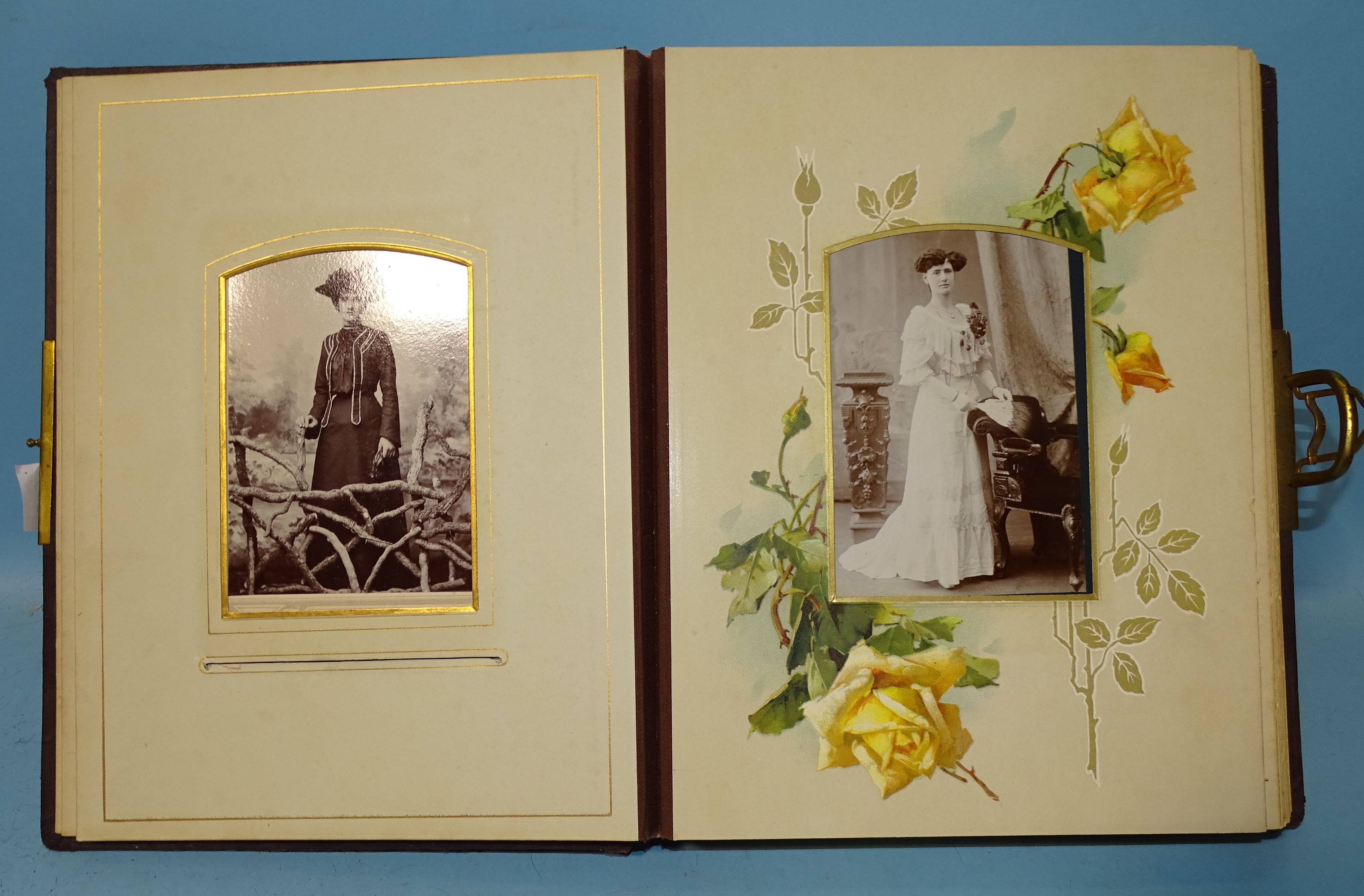 A Victorian leather-backed album of cartes de visite with some chromolithographed pages and brass