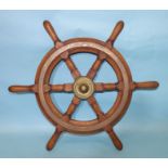 A teak six-spoke ship's wheel with brass central boss and circular fittings, 51.5cm diameter,