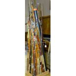 A large collection of split cane, fibreglass and wood fishing rods, (approximately 50).