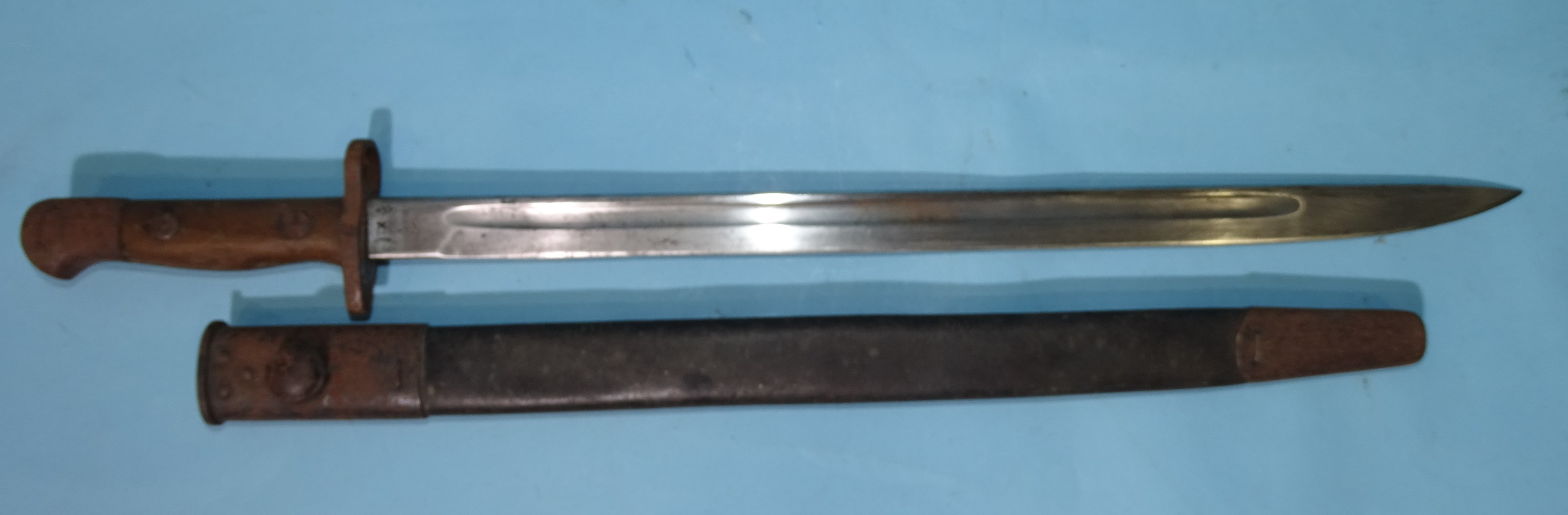 A British Army 1907 pattern bayonet by Wilkinson, the straight fullered blade with markings, in