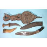 A pair of Chinese carved hardwood bellows, a kukri knife, an Indian hide or leather dahl shield (