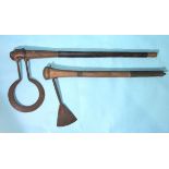 An unusual African axe, the iron hoop blade with engraved decoration and inserted through the shaft,