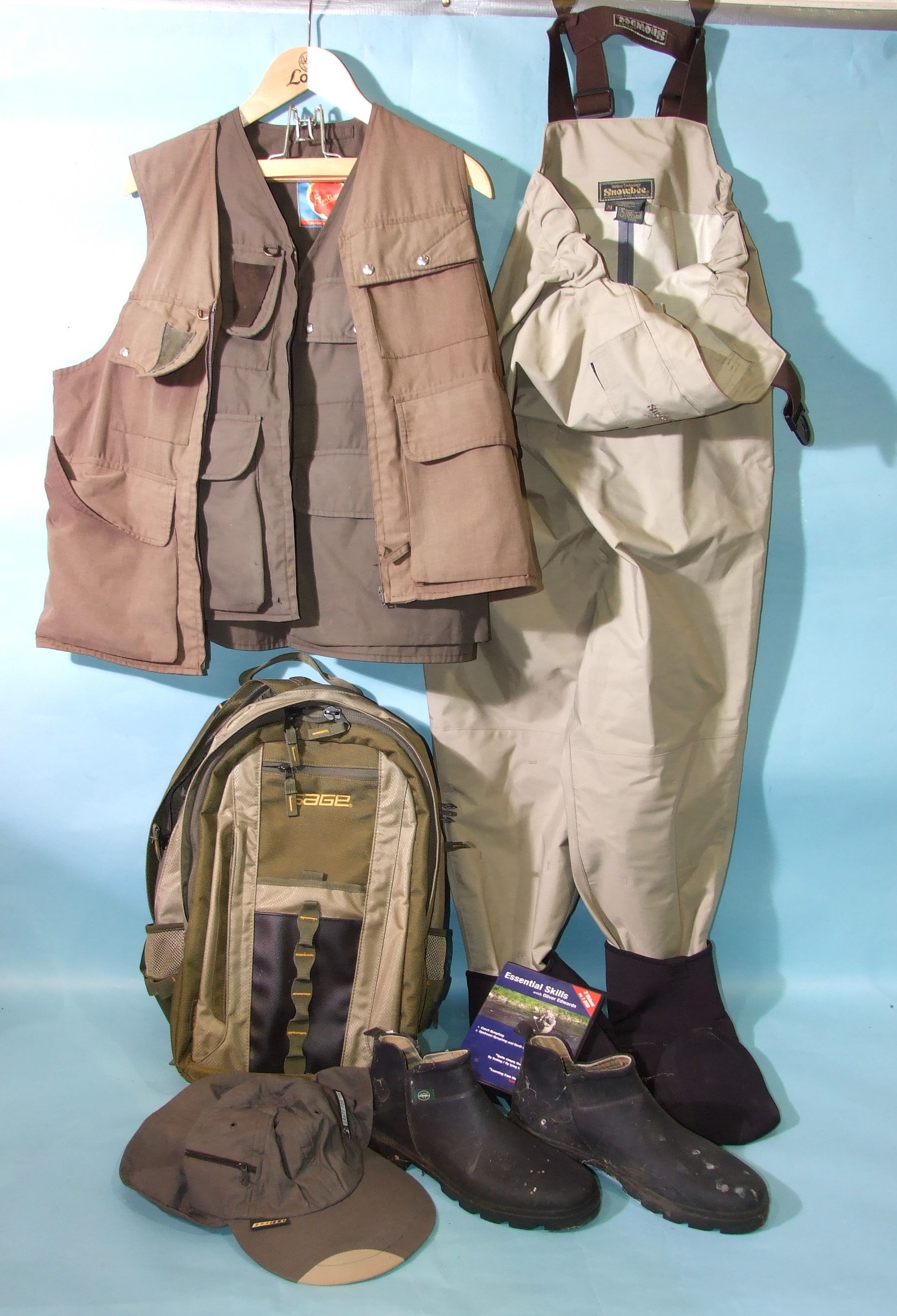A "Sage" rucksack, Snowbee chest waders (M), two fishing gilets and other fishing accessories.