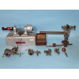 A clockmaker's bench lathe with various accessories including a compound cross slide, together